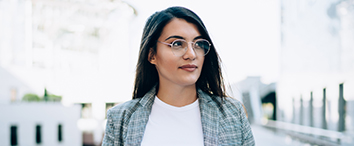 Picture of business woman with glasses standing outside