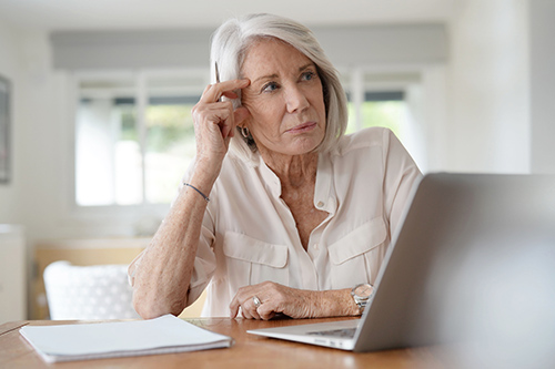 elderly-woman-working-on-computer-home